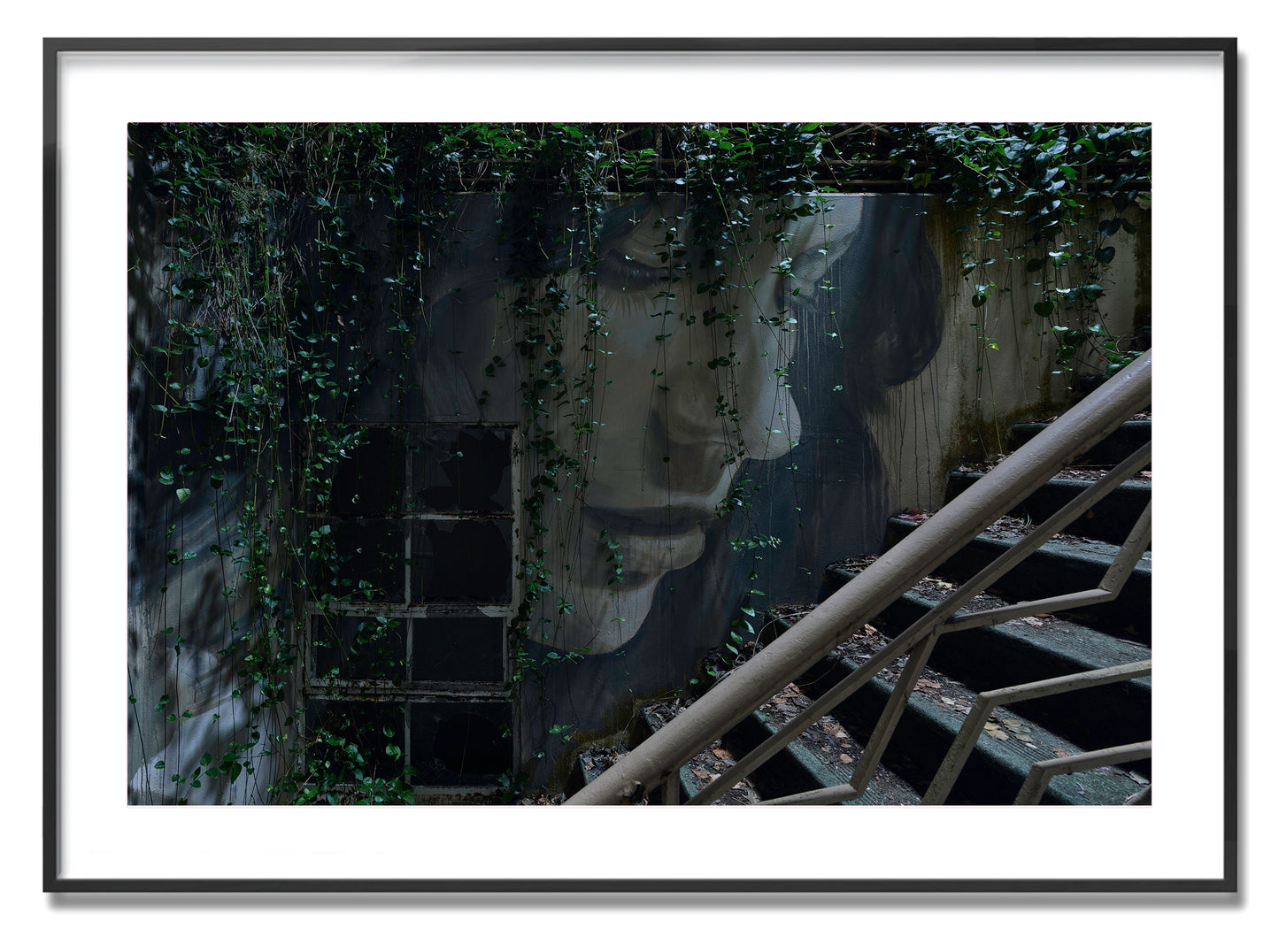 Image of Framed Print by Australian Artist Rone holding photographic print from Empire Exhibition.